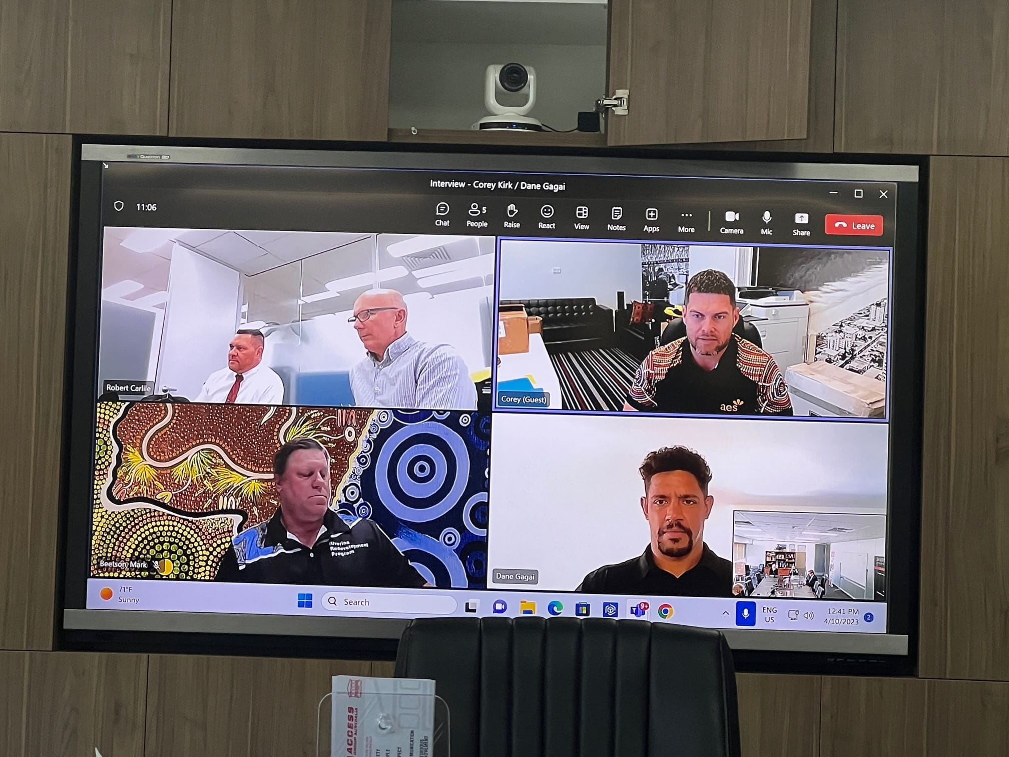 Virtual meeting on screen with multiple participants discussing project remotely