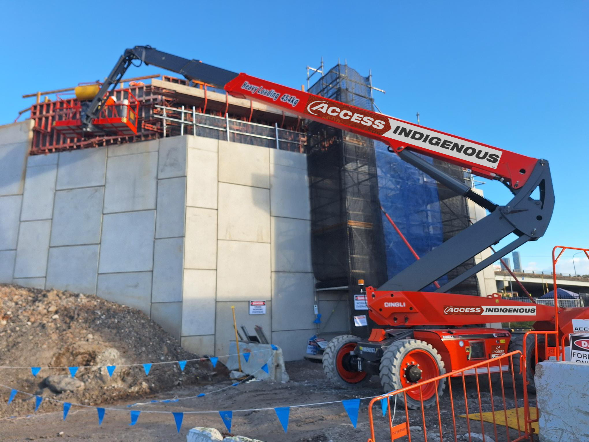 Access Indigenous boom lift operating at elevated construction site