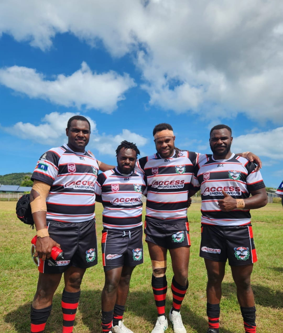 Access Indigenous rugby team players wearing Access Hire jerseys on sports field