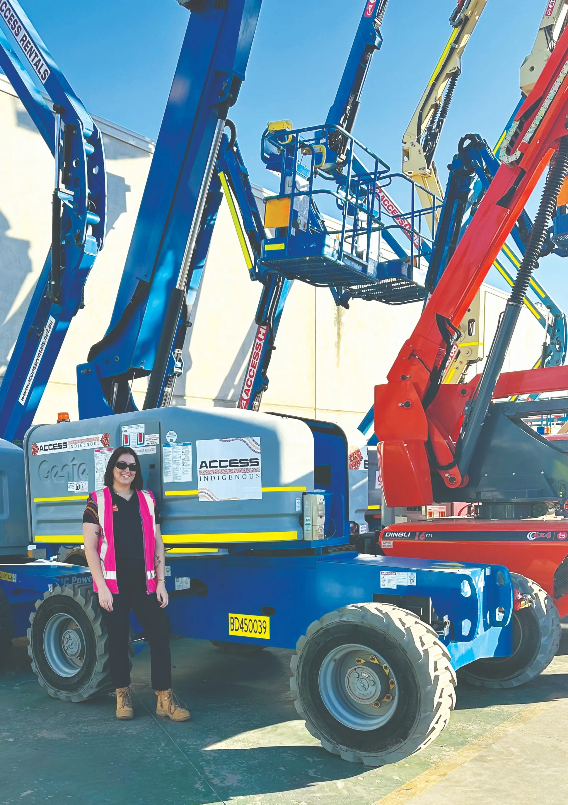 Access Hire boom lift with elevated platforms in yard